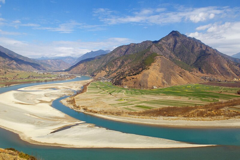 River Winding Through Valley — Blue, Serene, Afternoon, Photograph, Mountains, Fields, Village