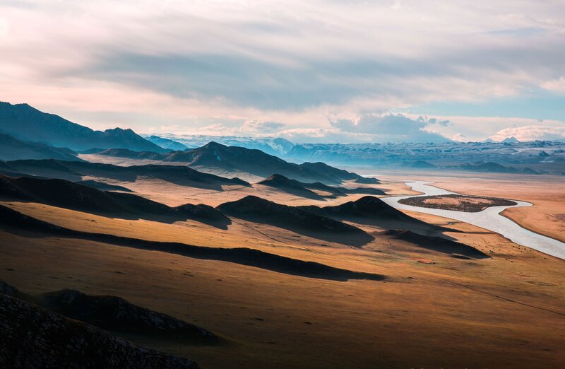 River Winding Through Valley — Brown