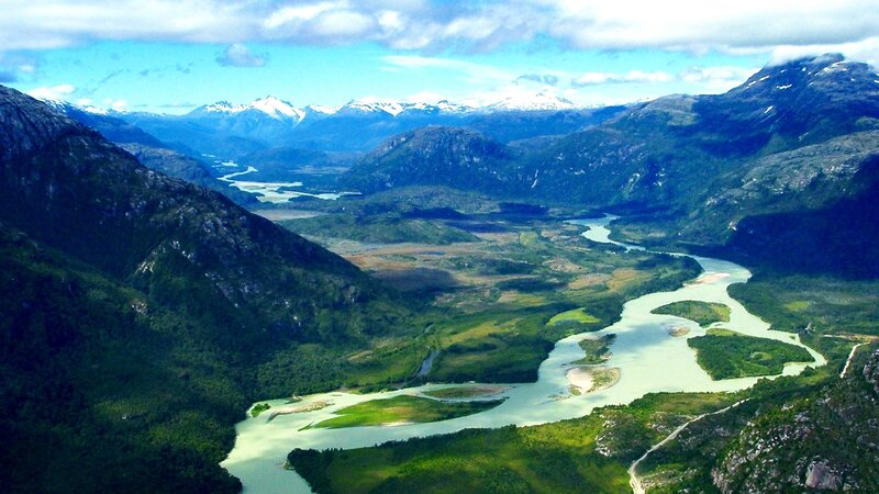 River Winding Through Valley — Green, Serene, Afternoon, Photograph, Mountains, Snow-capped Peaks