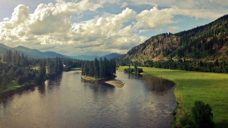 River Winding Through Valley — Green, Serene, Afternoon, Photograph, Mountains, Trees, Clouds