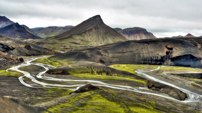 River Winding Through Volcanic Landscape — Green, Dramatic