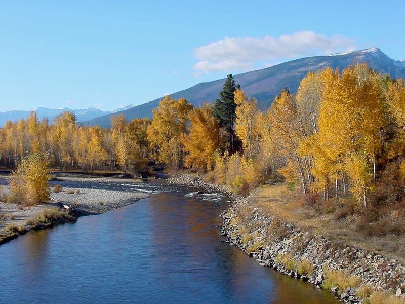 river with autumn trees and mountains