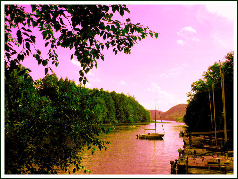 River with sailboats at sunset