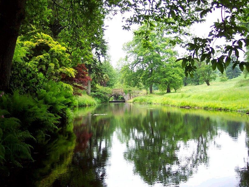 River with stone bridge in park