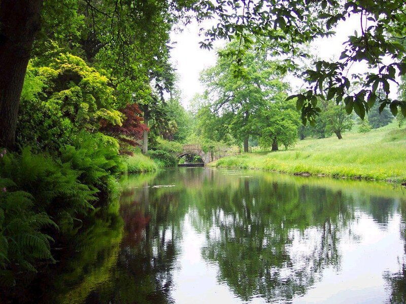 River with stone bridge in park