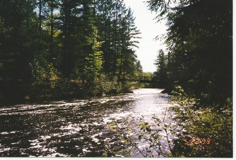 River with Wooden Bridge — Green, Serene, Afternoon