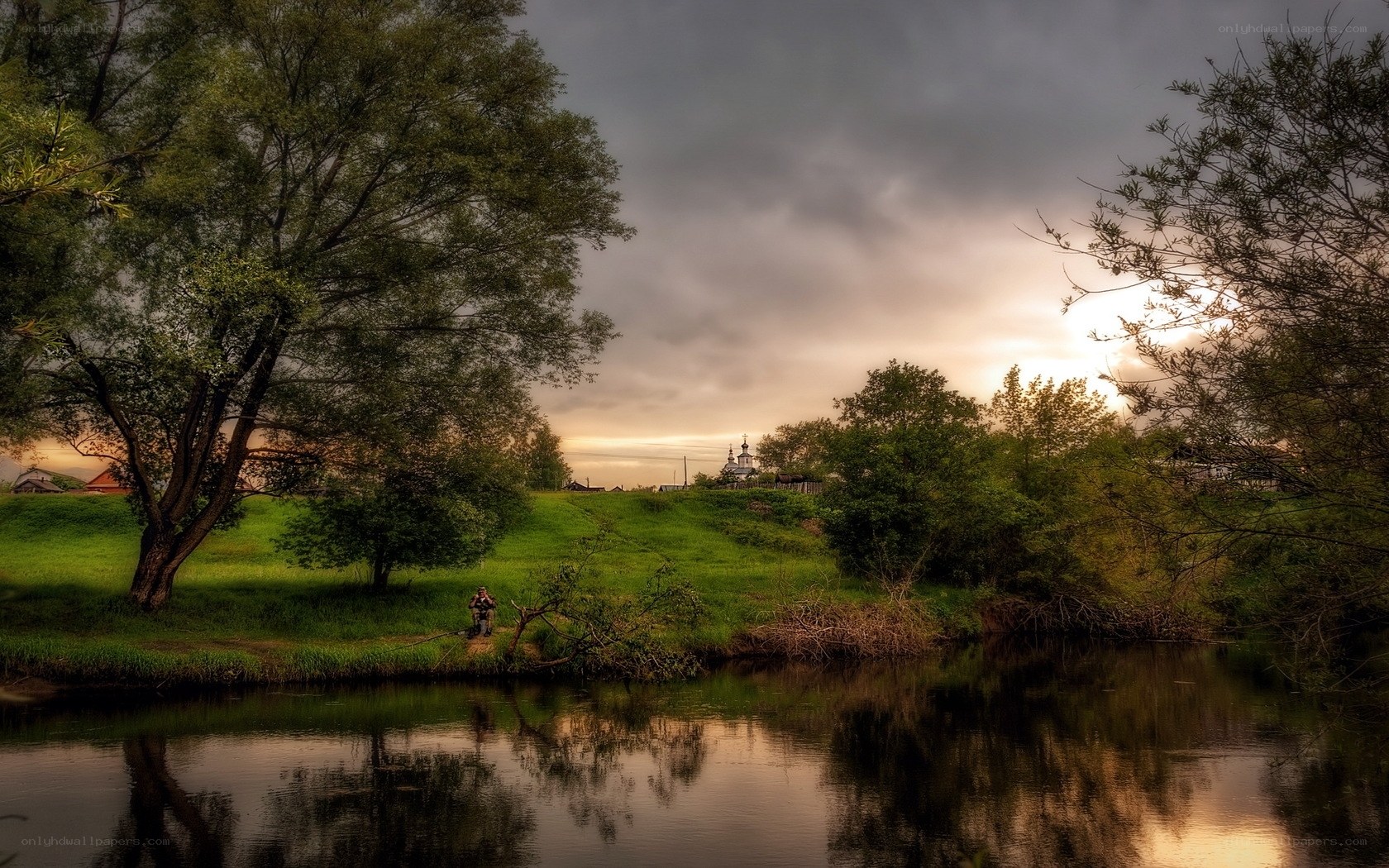 Riverbank at sunset with church
