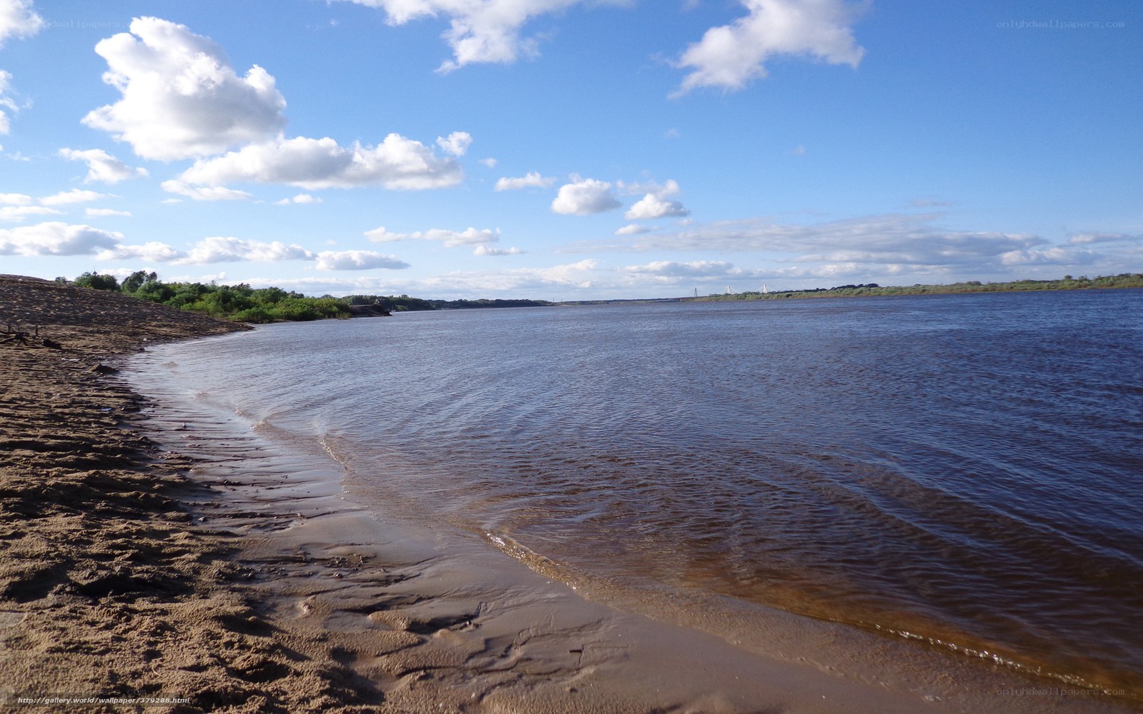 Riverbank under blue sky