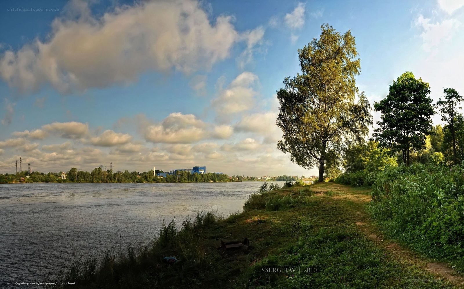 Riverbank with trees and clouds