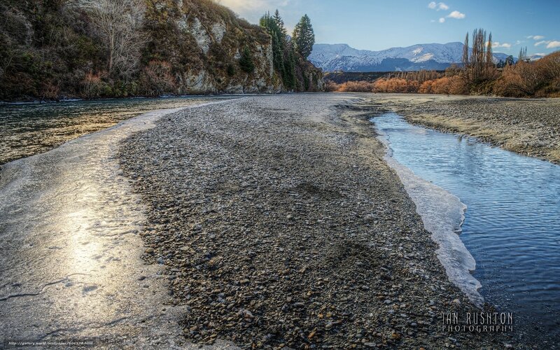 Riverbed with snow-capped mountains