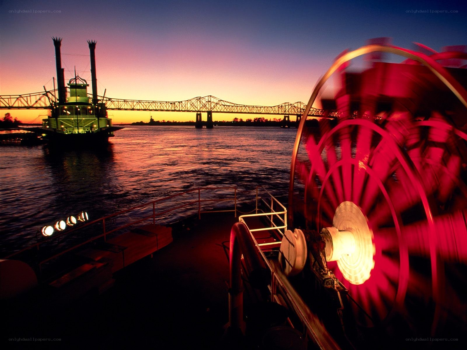 Riverboat at sunset with paddlewheel