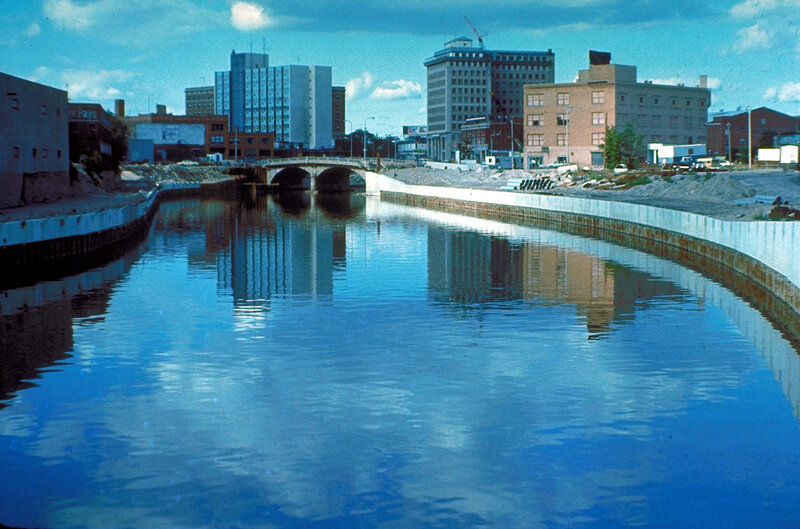 Riverfront cityscape with bridge