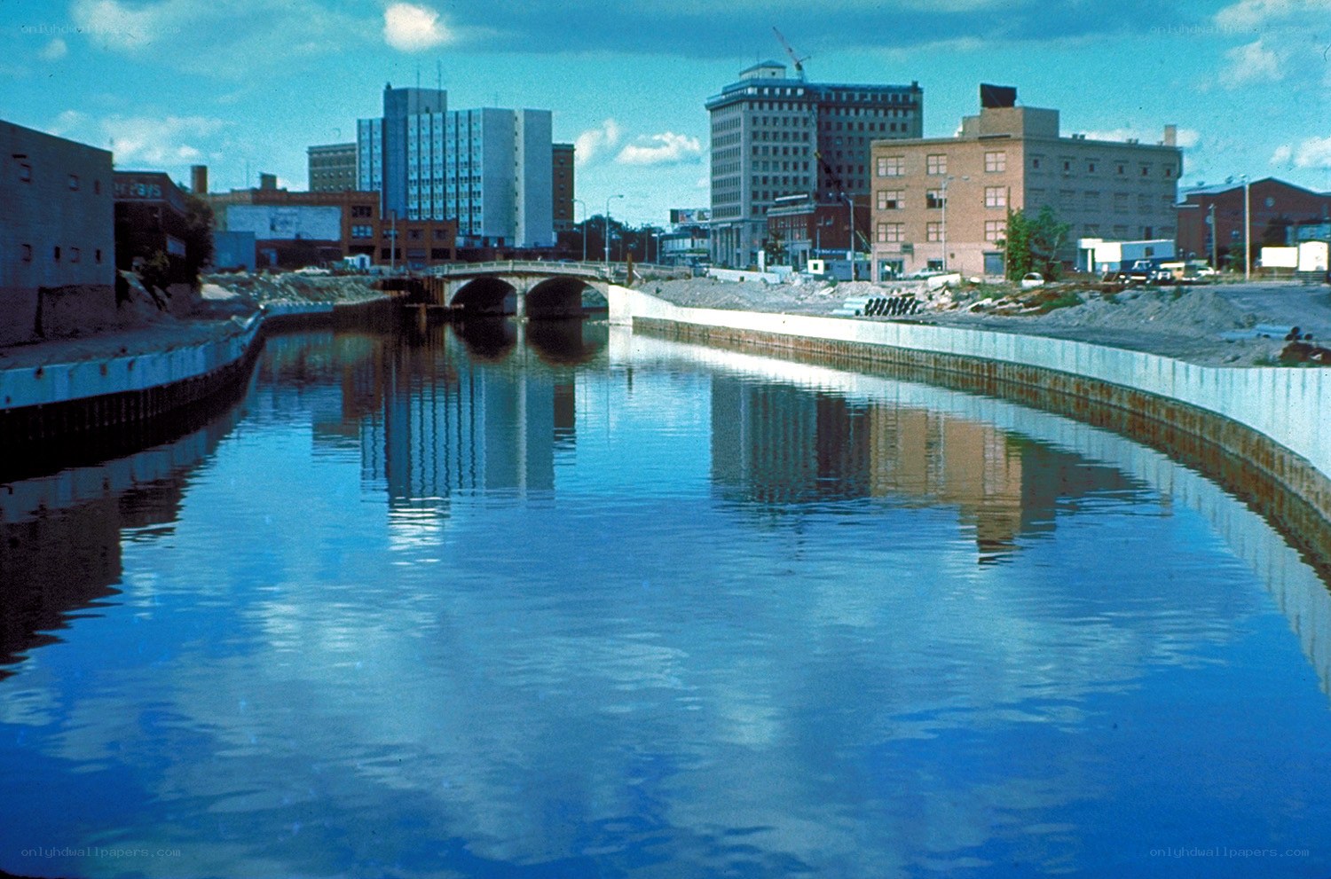 Riverfront cityscape with bridge