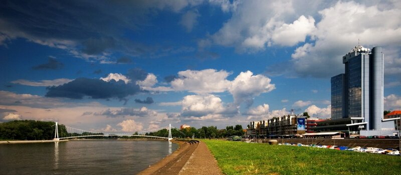 Riverfront with modern bridge and skyscraper