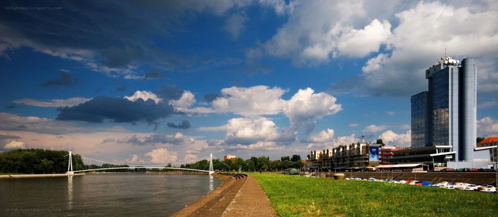 Riverfront with modern bridge and skyscraper