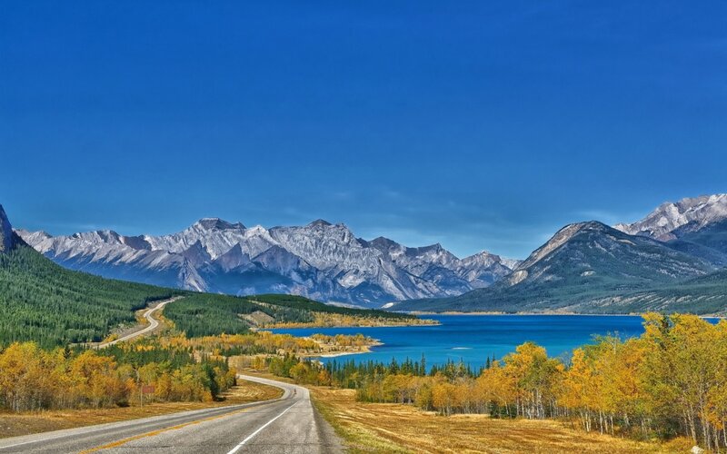 Road Along Lake and Mountains