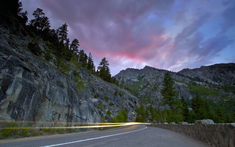 Road at dusk with mountain backdrop
