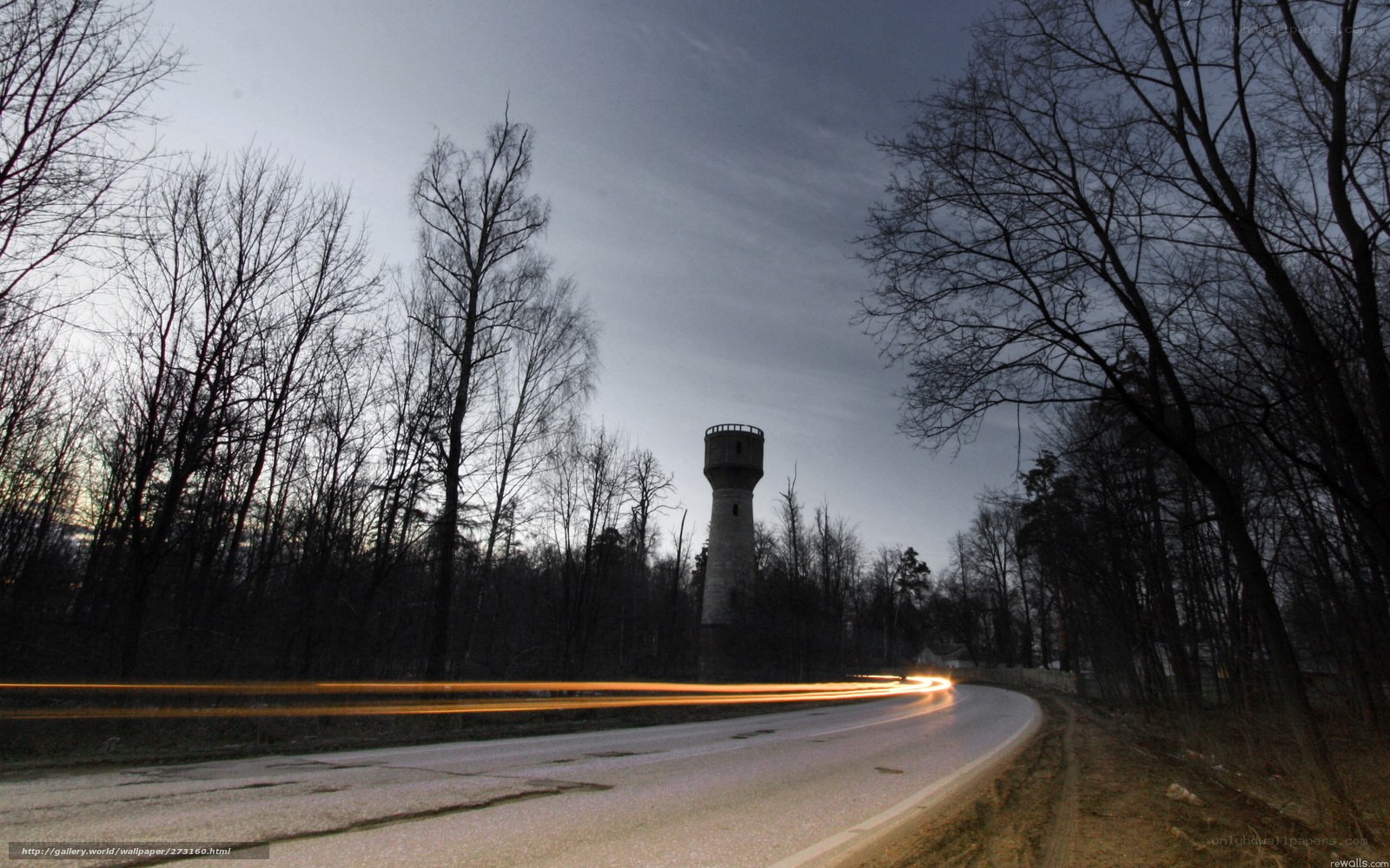 Road at dusk with water tower