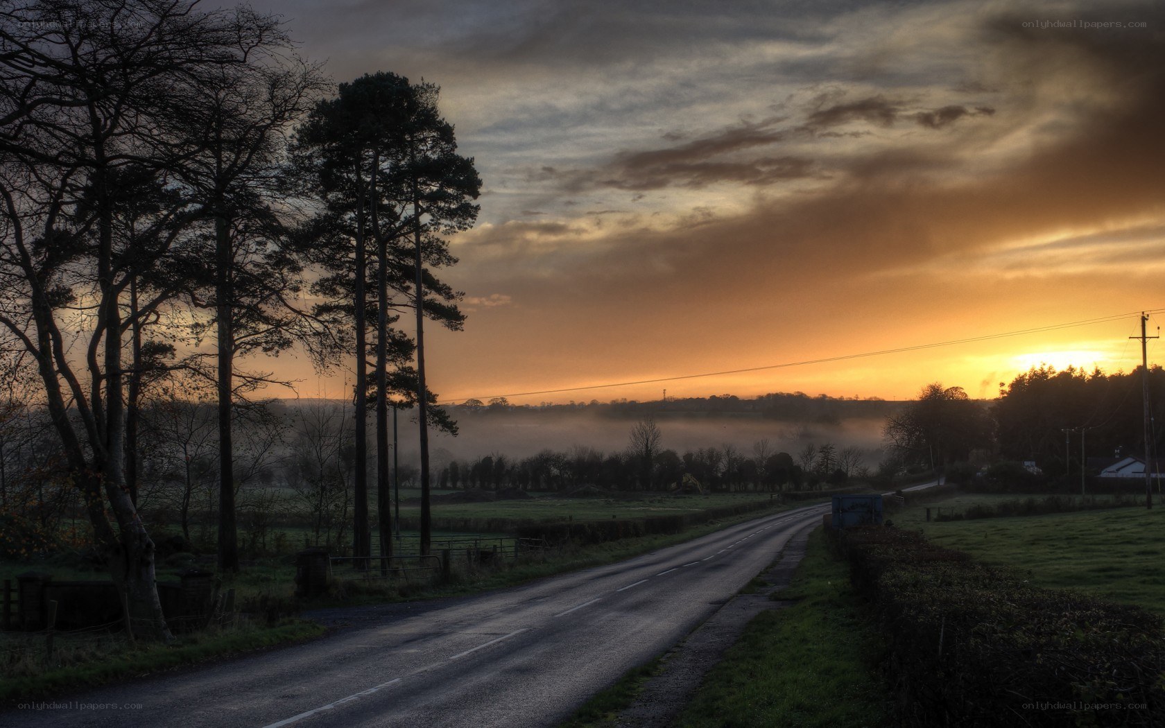 Road at sunrise with mist
