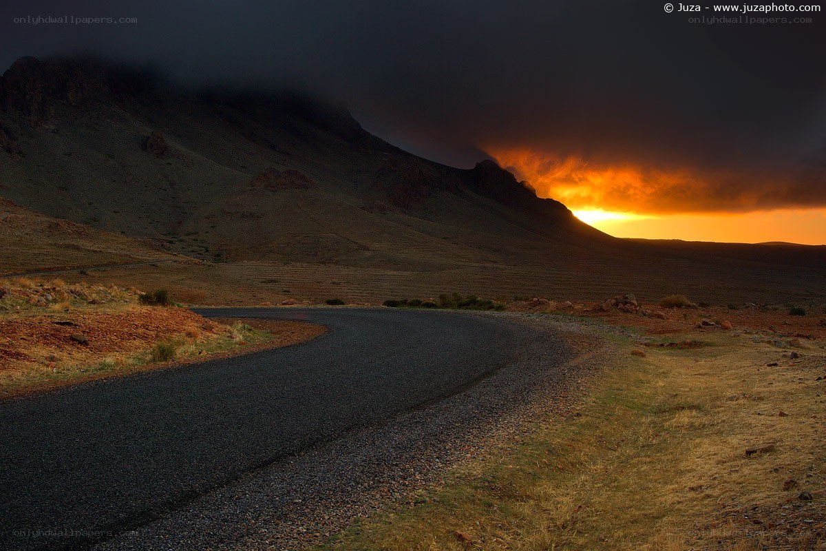 Road at sunset in mountainous terrain
