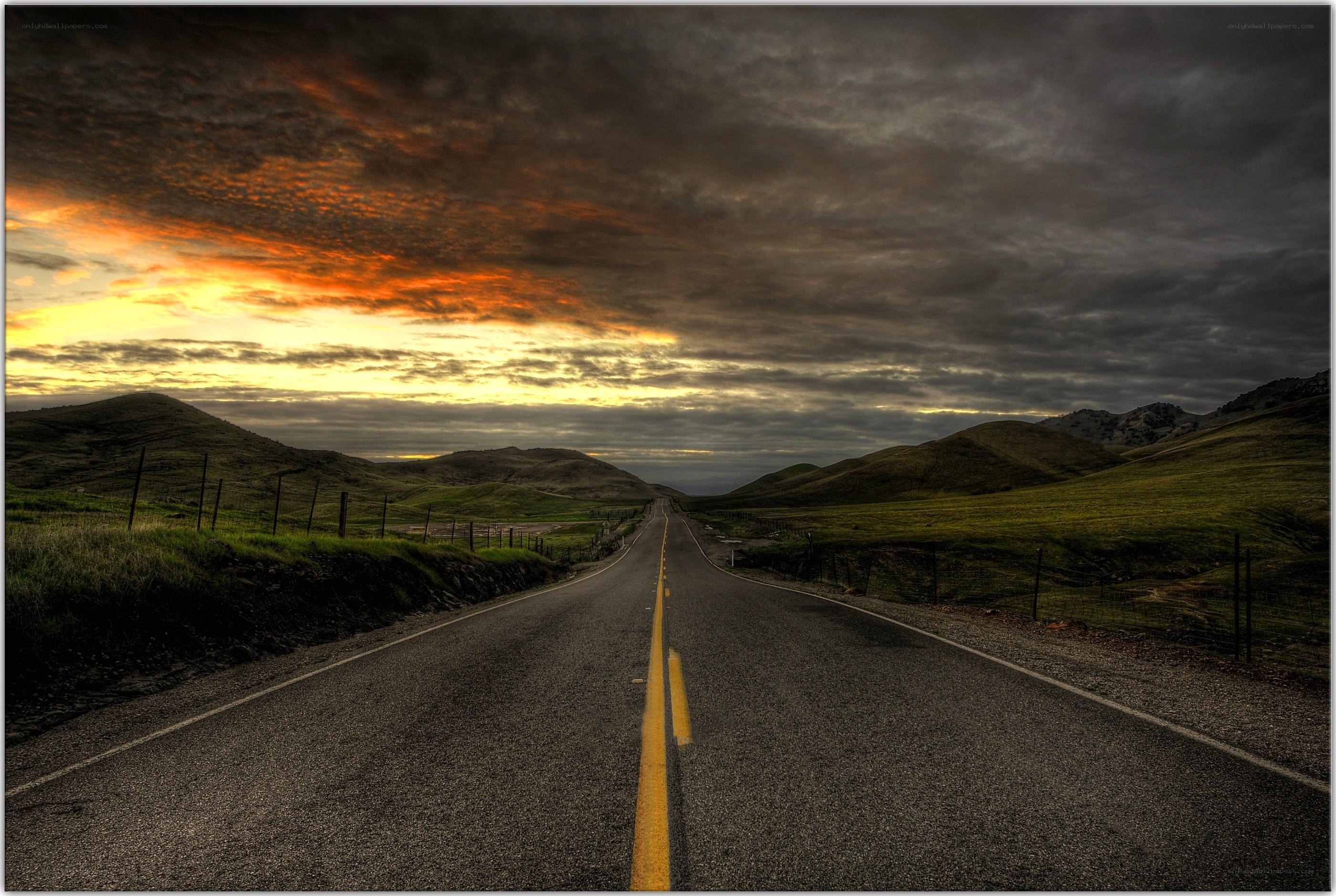 Road at sunset in rolling hills