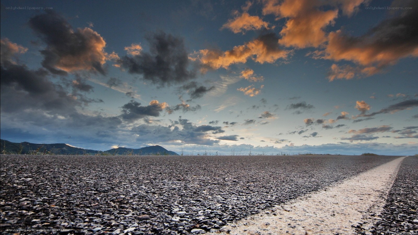 Road at sunset with clouds