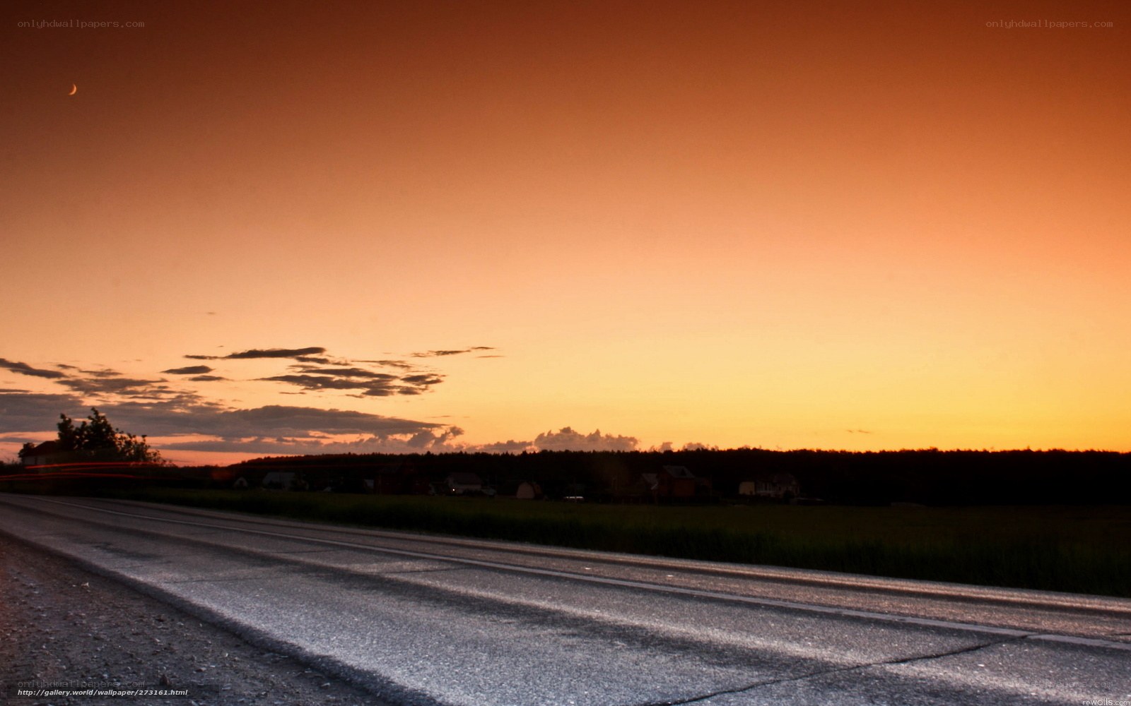 Road at sunset with crescent moon