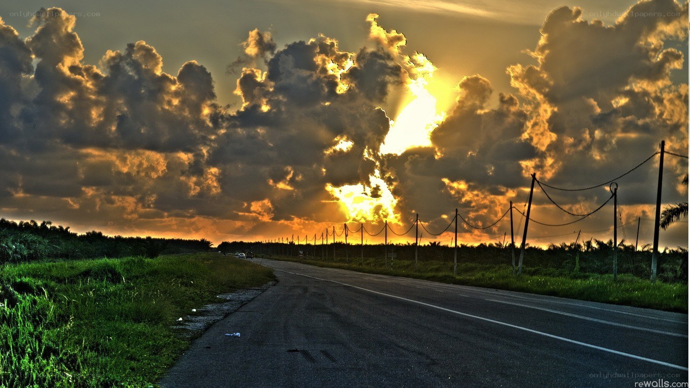 Road at sunset with dramatic clouds