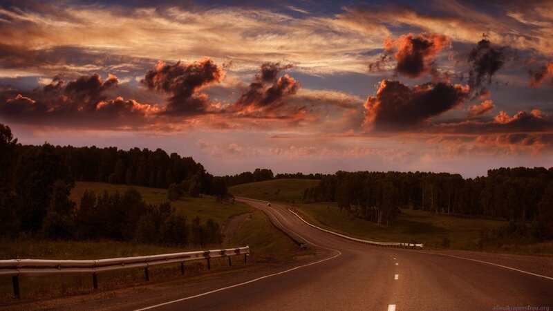 Road at sunset with dramatic clouds