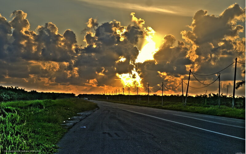 Road at sunset with dramatic clouds