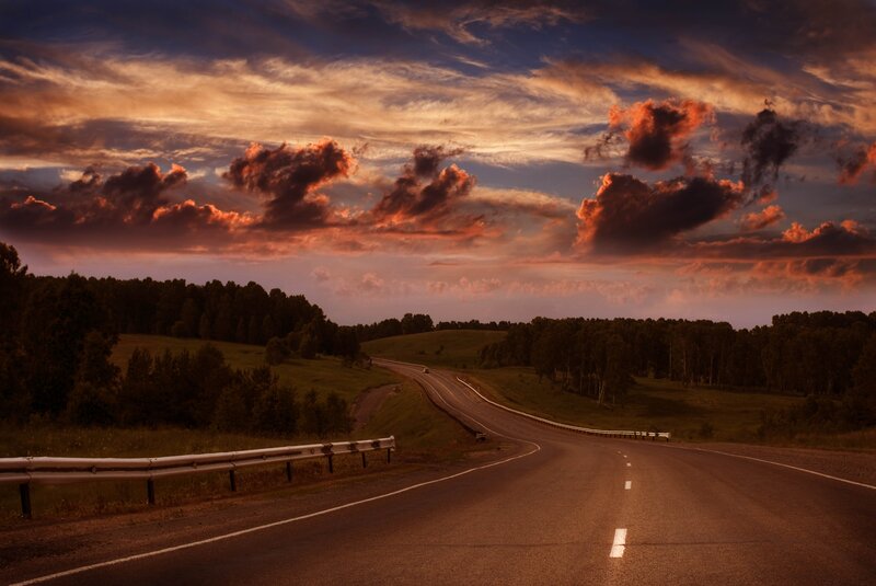 Road at sunset with dramatic sky