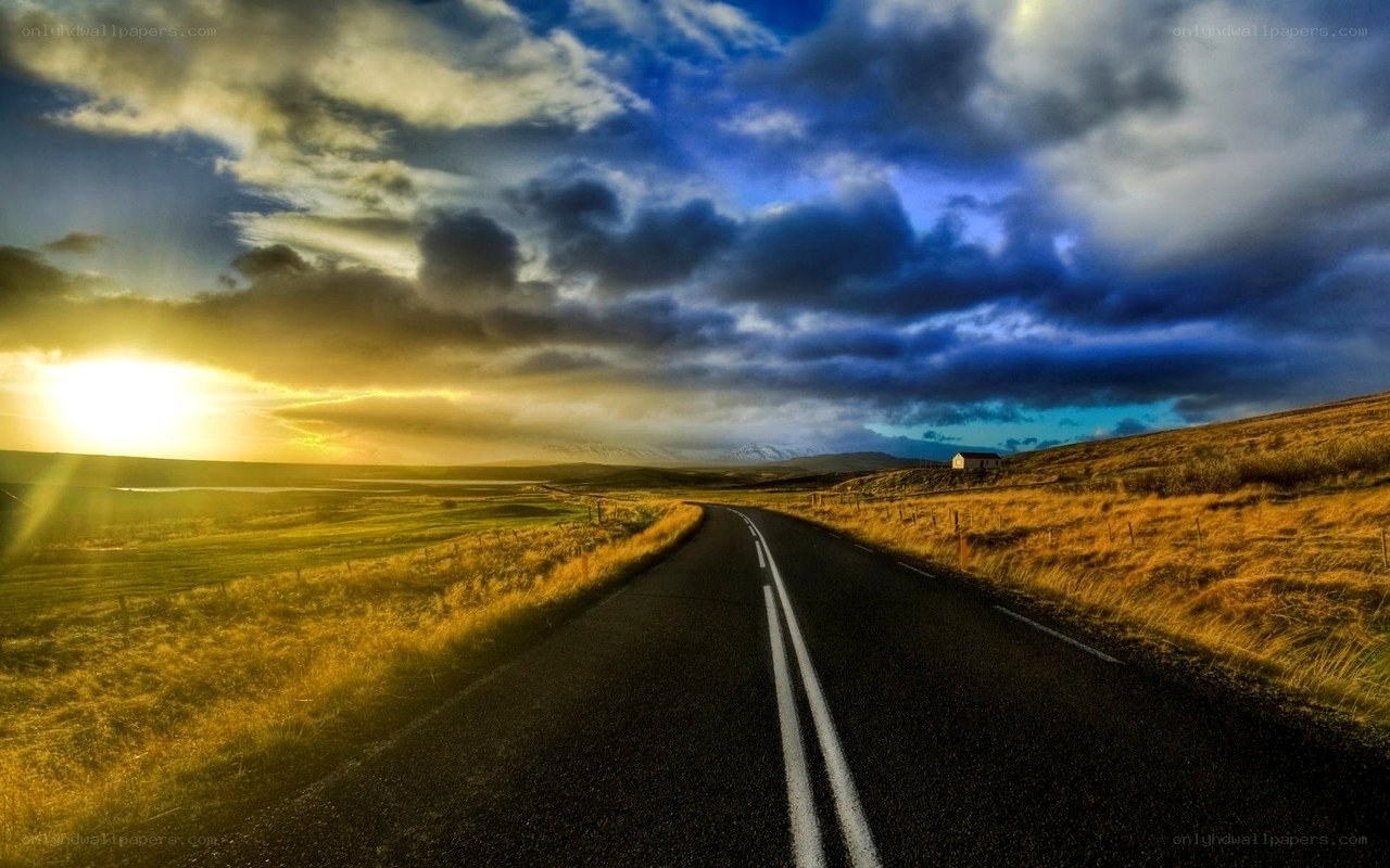 Road at sunset with dramatic sky
