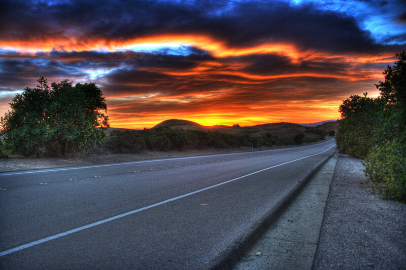 Road at sunset with dramatic sky