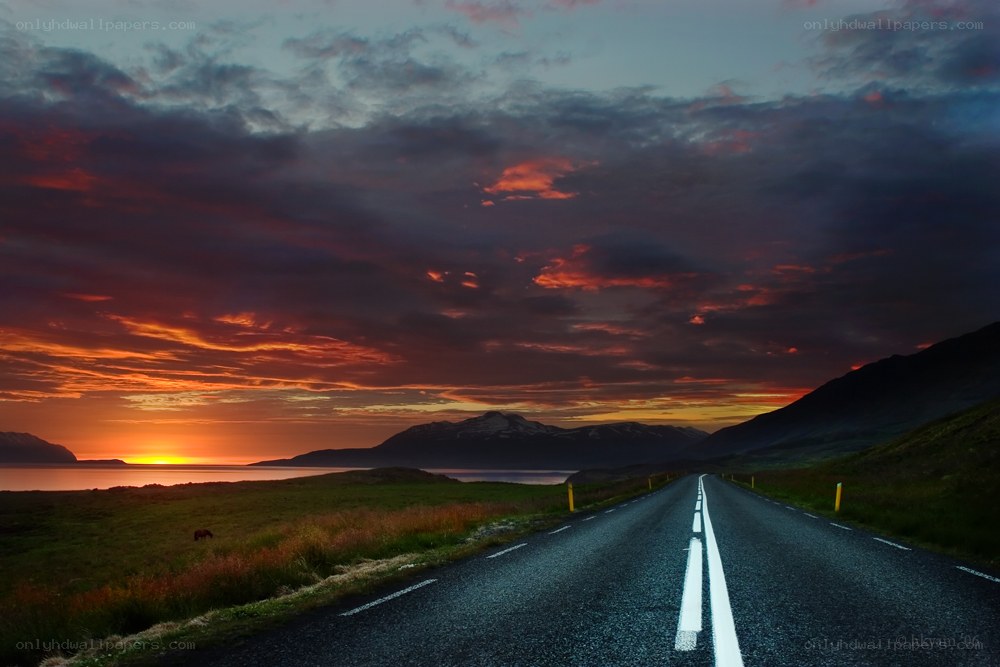 Road at sunset with mountains
