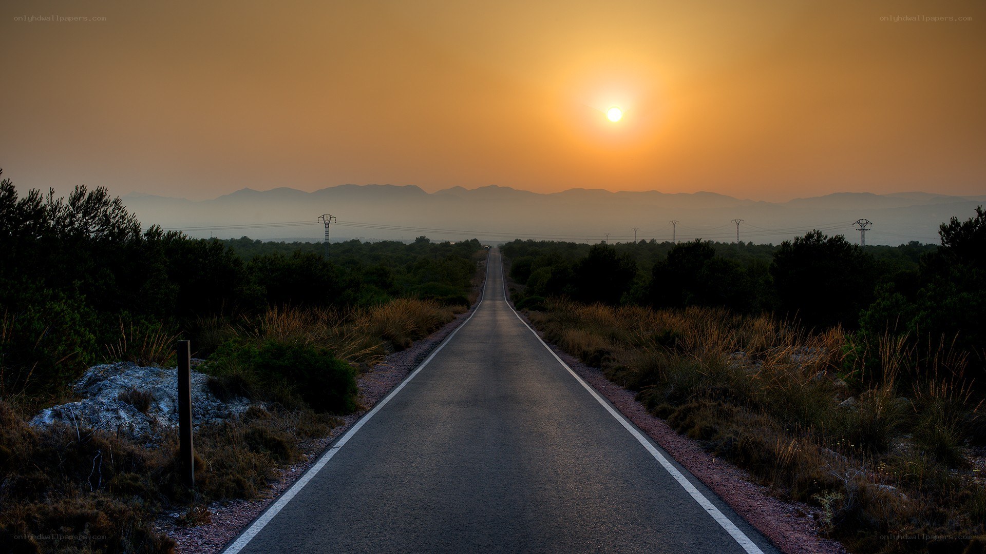 Road at sunset with mountains