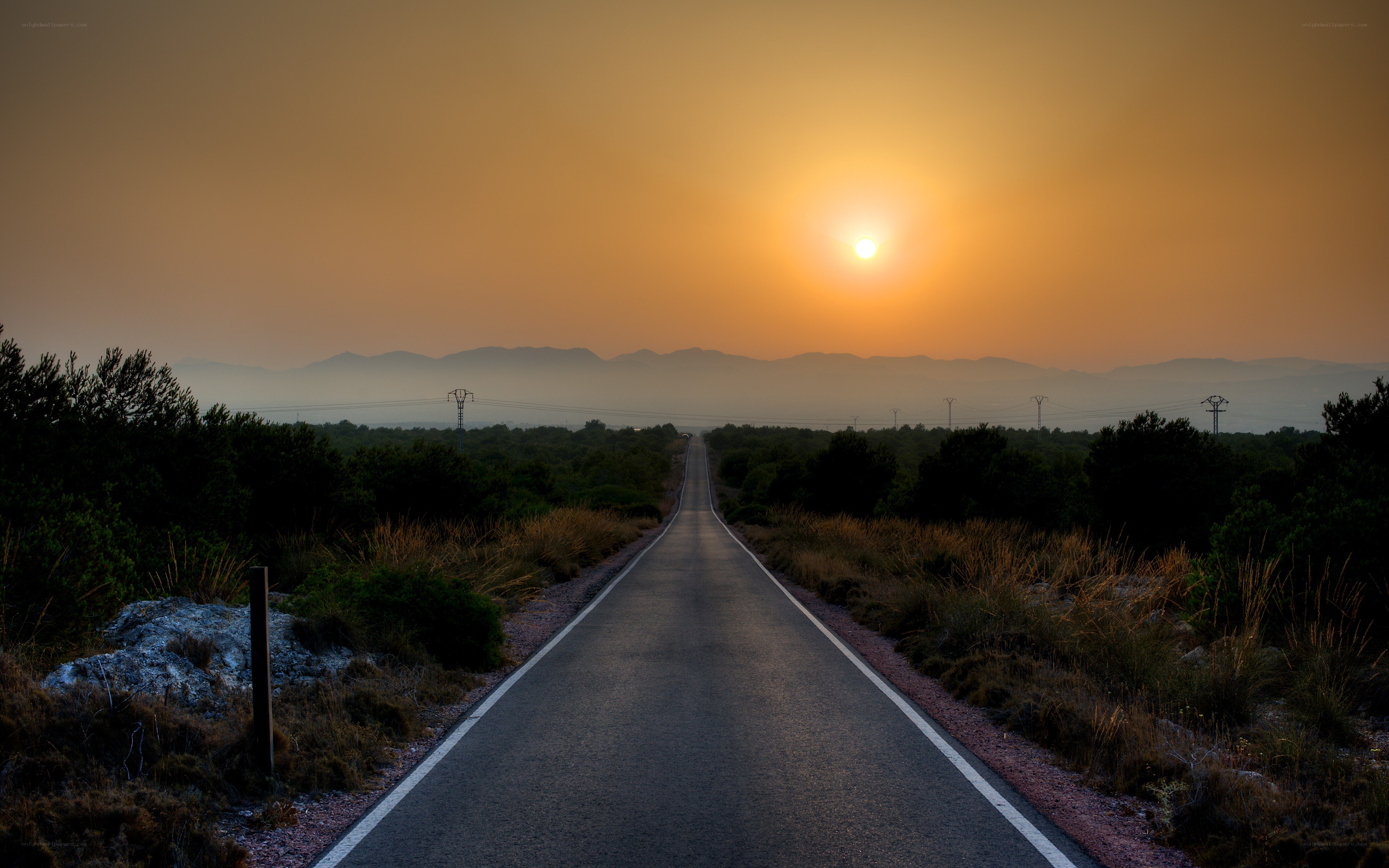 Road at sunset with mountains