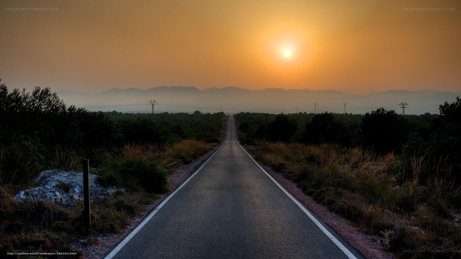 Road at sunset with mountains