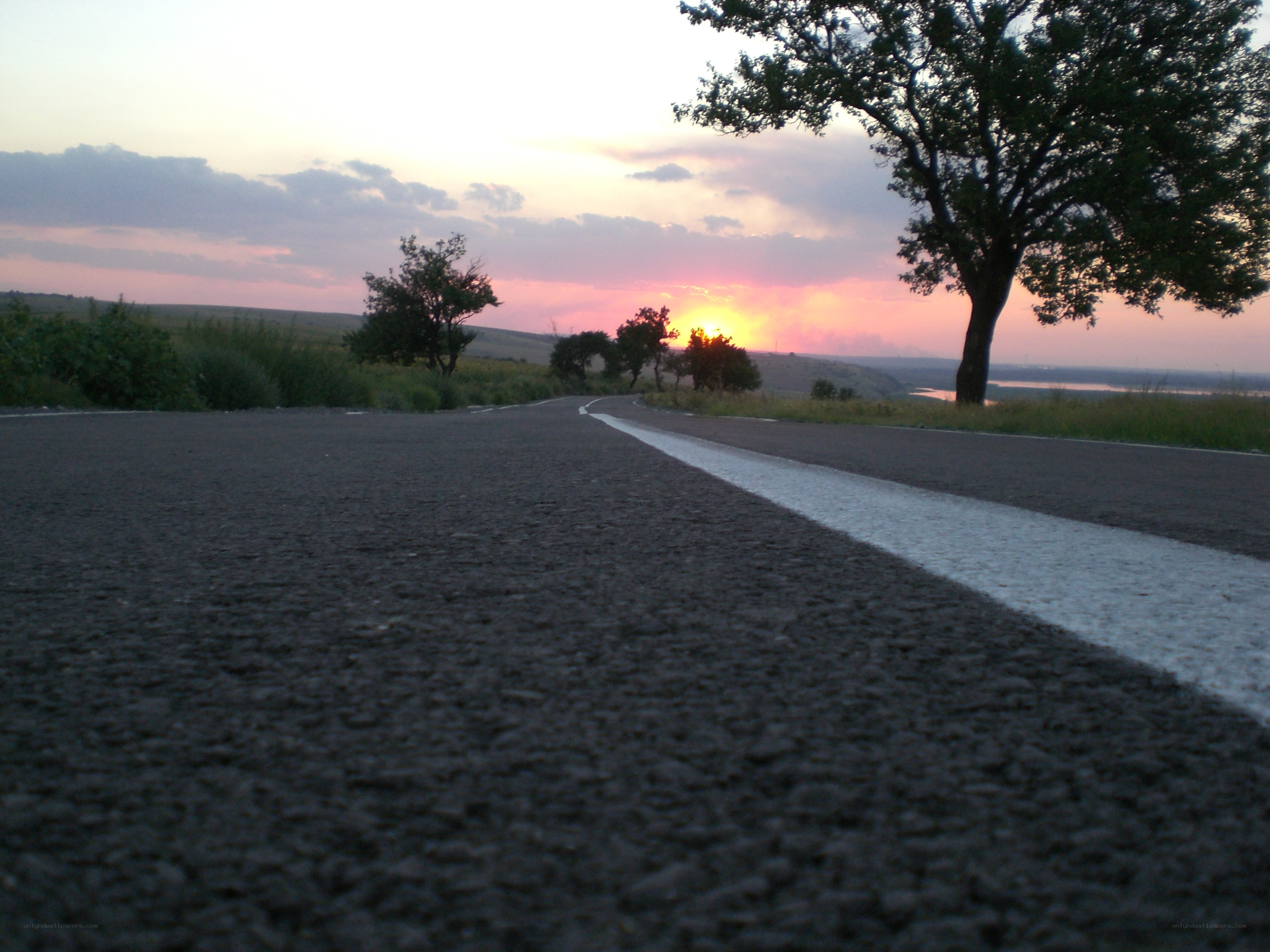 Road at sunset with river view