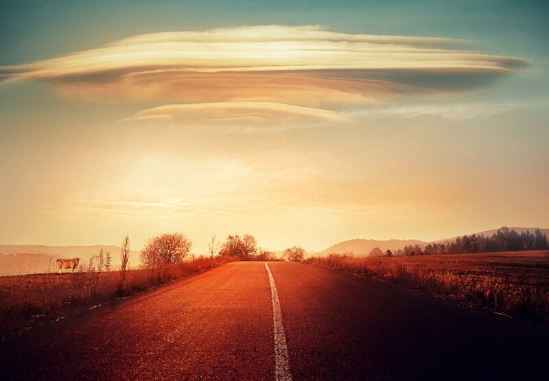 Road at sunset with unique clouds