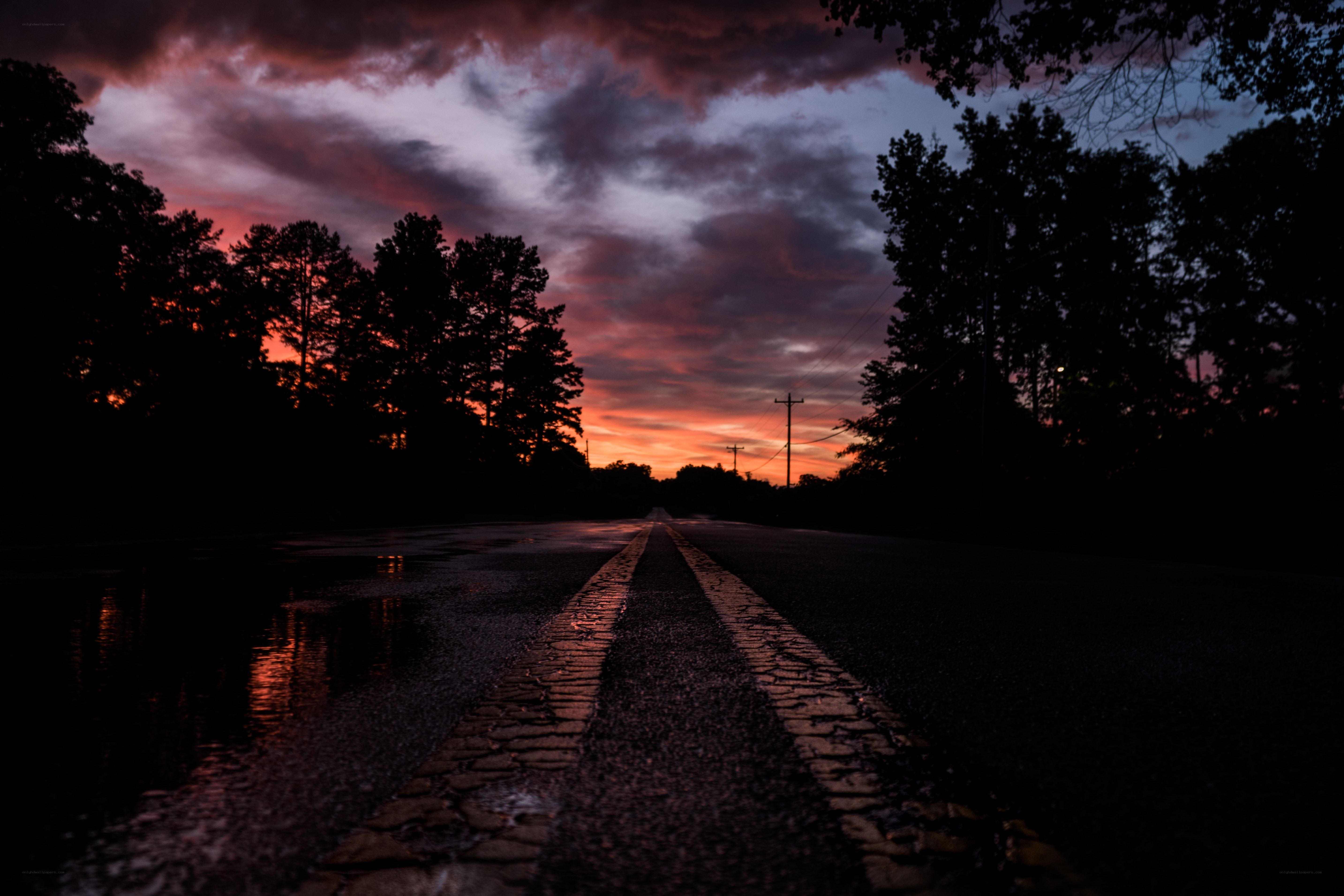 Road at sunset with wet pavement