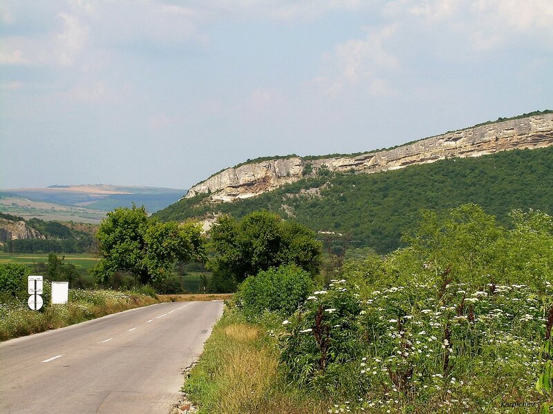 Road beside a rocky hill