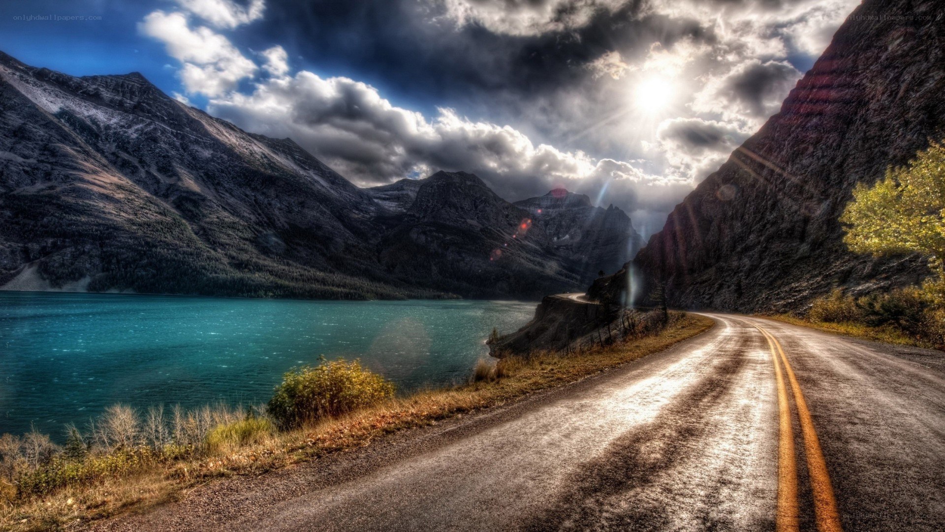 Road beside a turquoise lake
