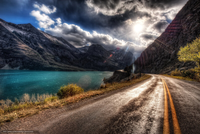 Road beside a turquoise lake