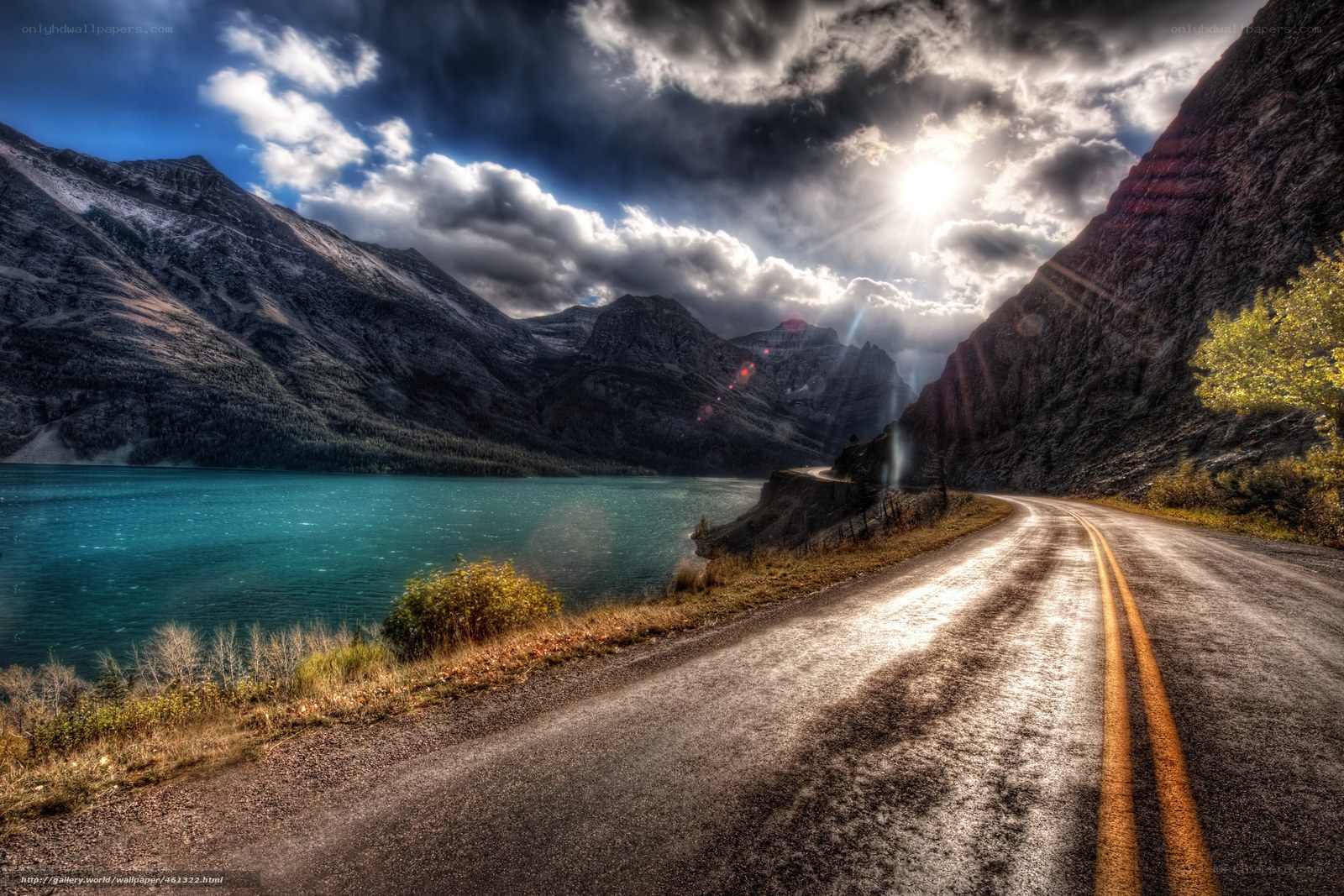 Road beside a turquoise lake