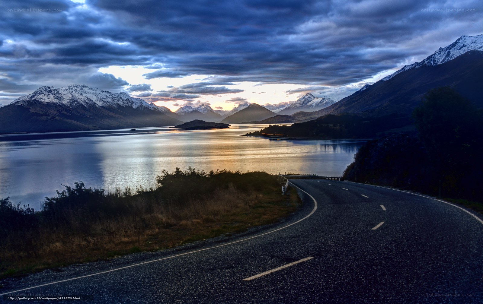 Road by a lake at sunset