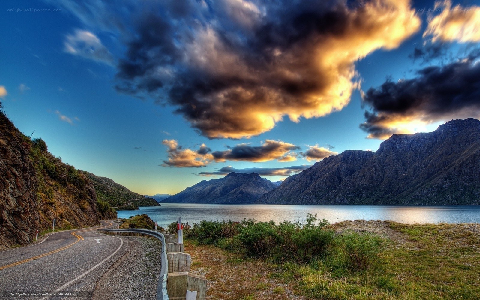 Road by lake at sunset