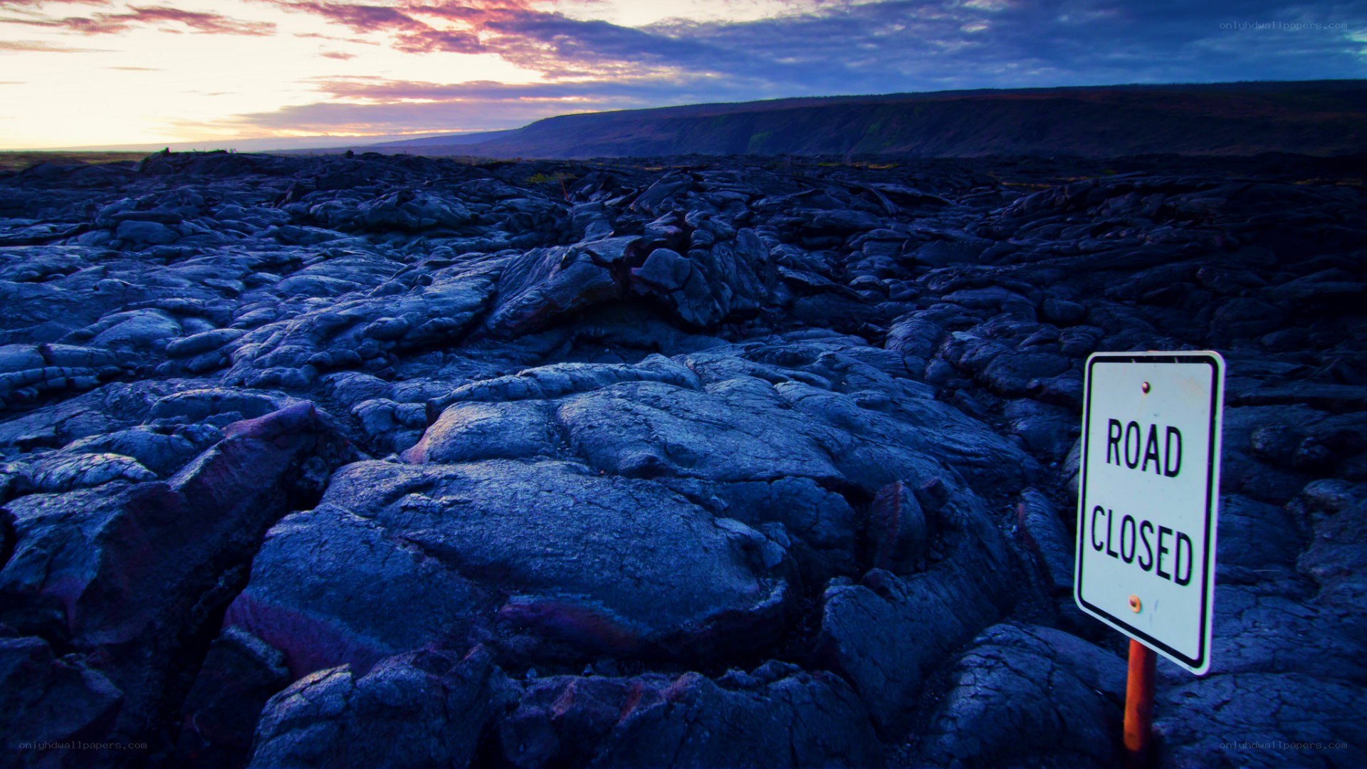 Road closed sign on lava field