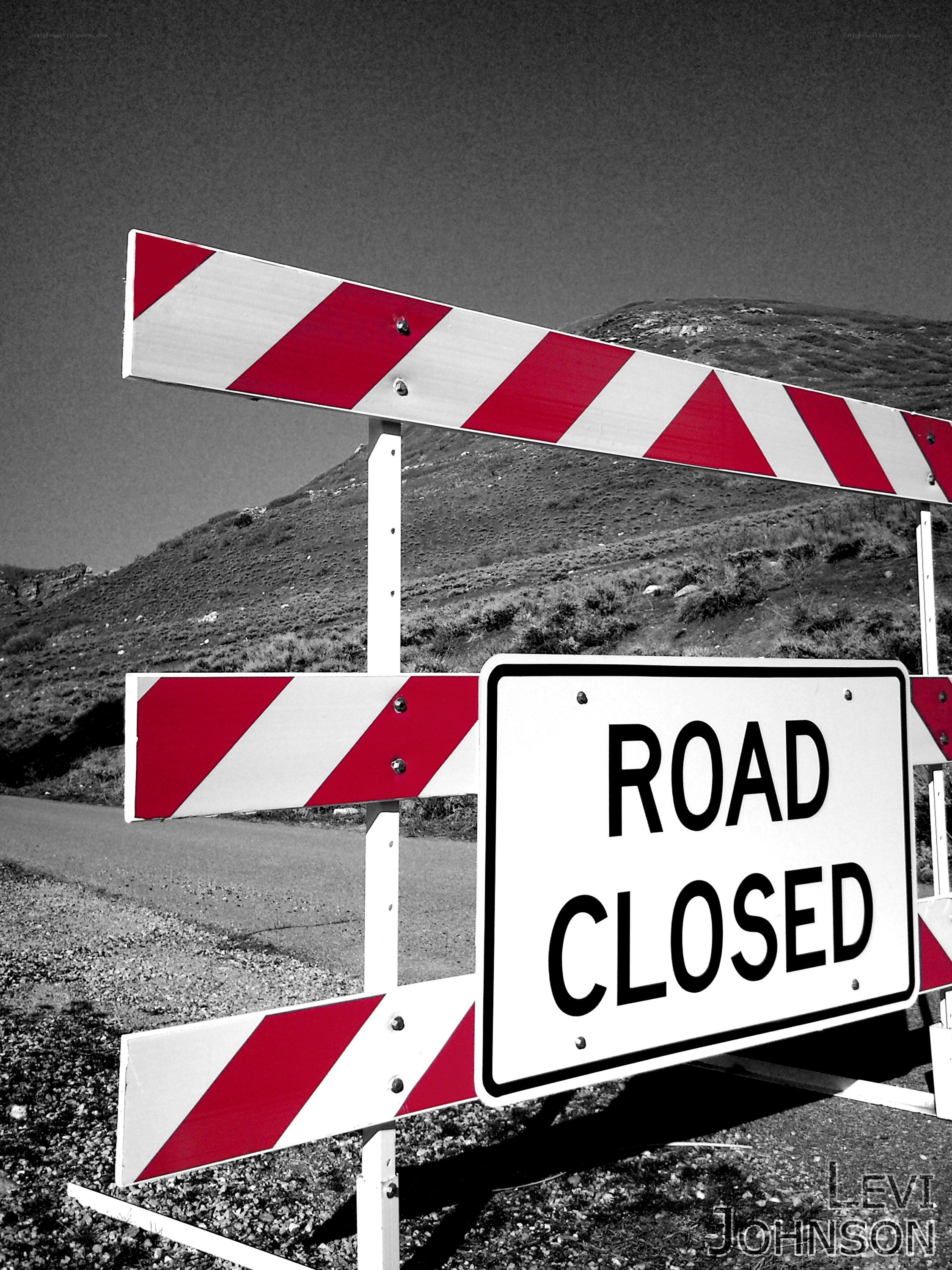 Road closed sign with barricade