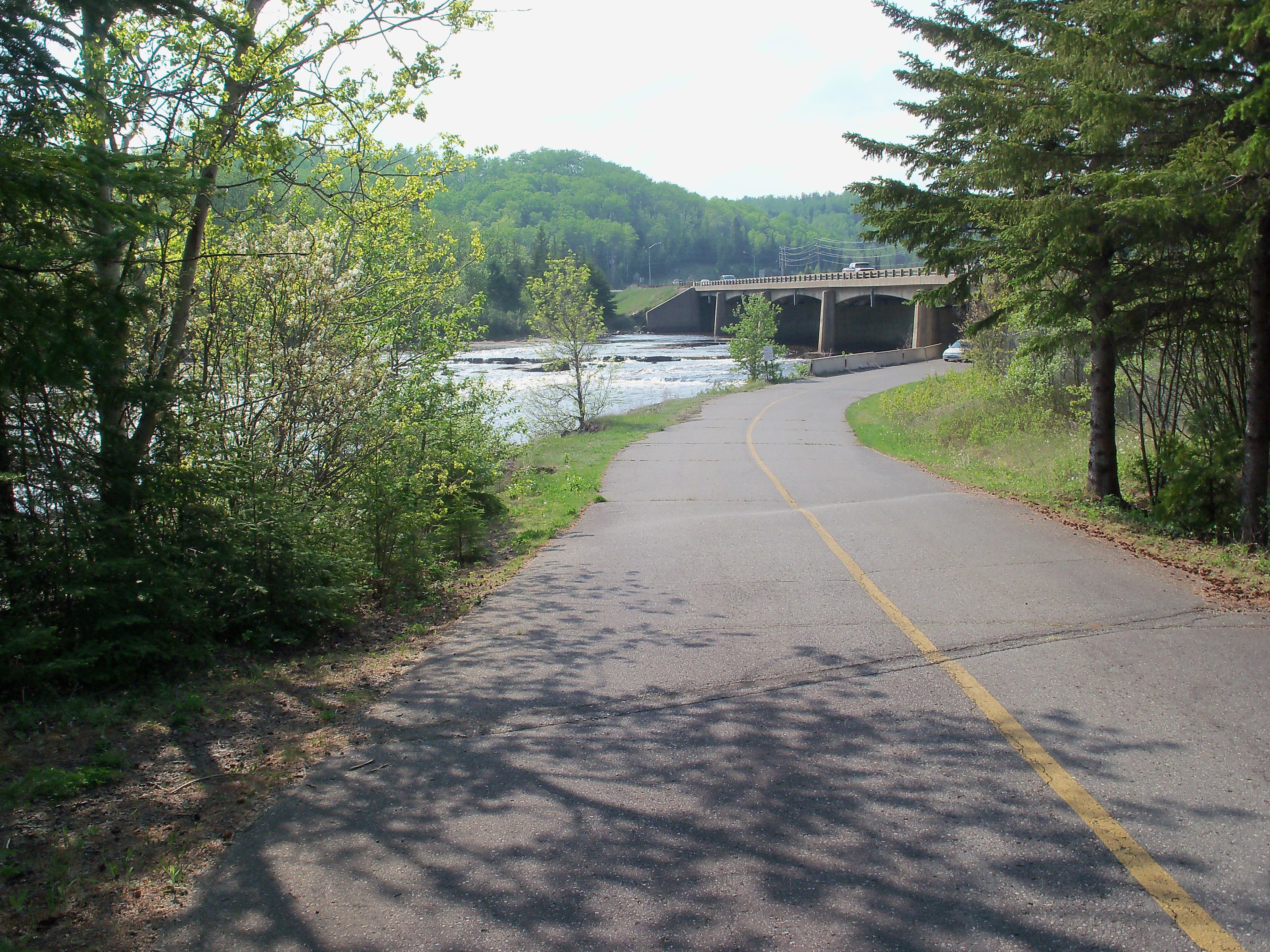 Road leading to a river bridge