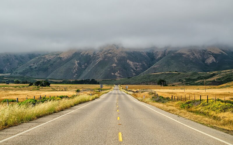 Road leading to foggy mountains